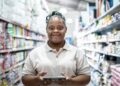 Portrait of a young woman with Down syndrome working on a digital tablet at the supermarket